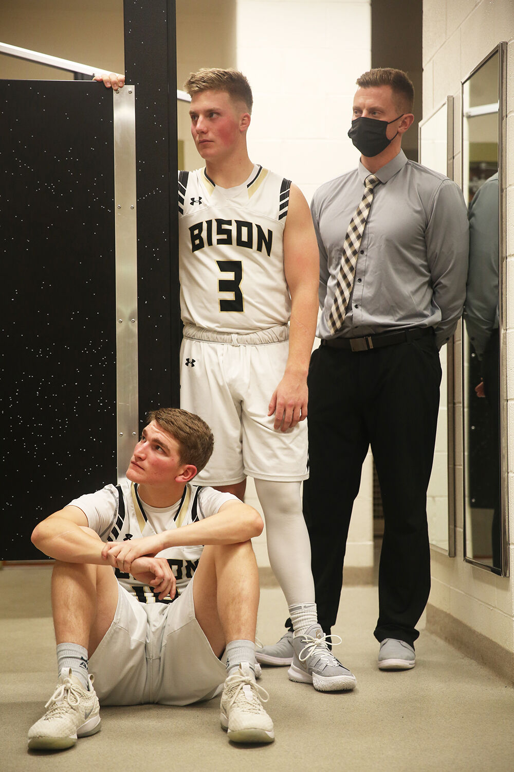 Taylor Swanston, sitting, and Hyrum Hatch listen to head coach Tanner Hart